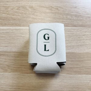Griffith Leagues Club stubby holder upright on timber surface showing GL logo